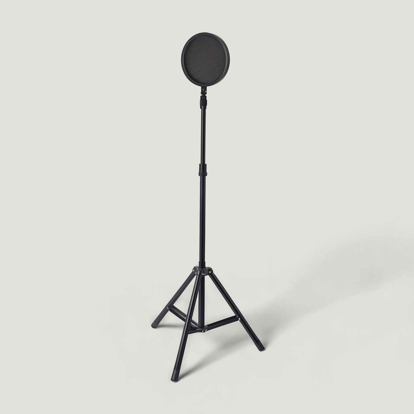 Round pop filter mounted on a tripod stand