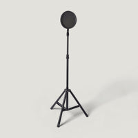 Round pop filter mounted on a tripod stand