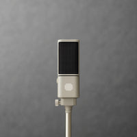 Close-up of a cream SOVA R1 microphone on a stand against gray